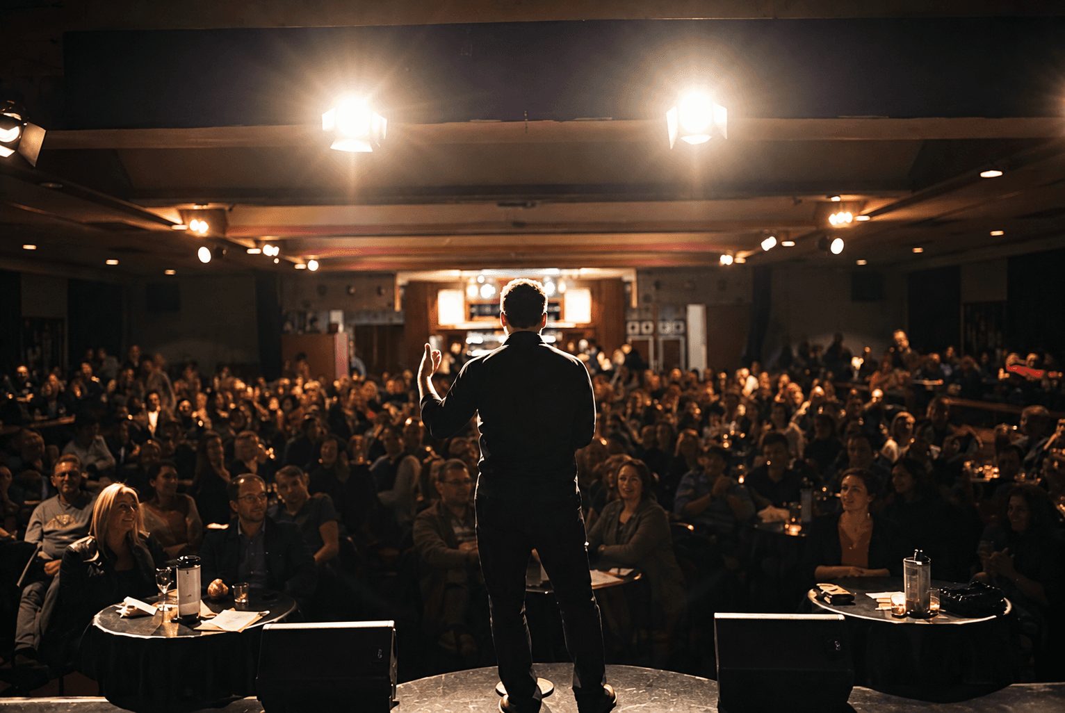 Comedian performing to a full room at The Comics Lounge